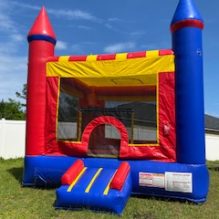 Front view of castle moon bounce house, orange, yellow, blue, green & blue castle.